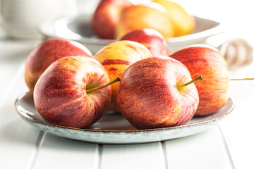 Fresh autumn apples on plate.