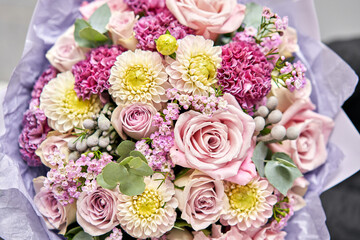 Beautiful bouquet of mixed flowers in woman hand. Floral shop concept . Beautiful fresh cut bouquet. Flowers delivery