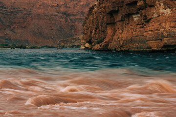 Fototapeta na wymiar Red rocks and Colorado River after the storm at sunset