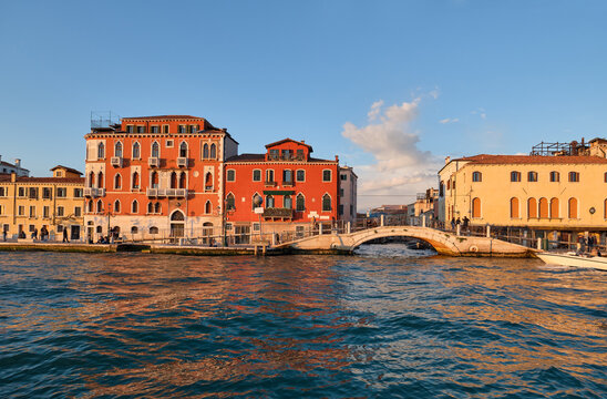 Architecture in Venice, Italy. Pedestrian bridge next to historical gondola boat repair yard Trovaso in beautiful evening light. Fondamenta Zattere or Raft fondation.