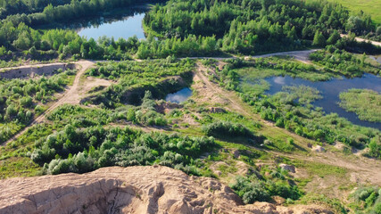 Flooded and overgrown sand quarry. Lush green summer landscape for outdoors vacation, hiking, camping or tourism. Volokolamsk district of Moscow region. Sychevo beach, Russia