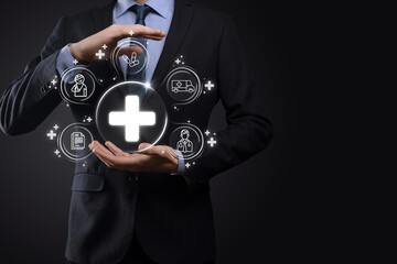 Businessman hold virtual plus medical network connection icons. Covid-19 pandemic develop people awareness and spread attention on their healthcare.Doctor,document,medicine,ambulance,patient icon.