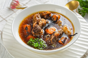 beef broth of beef meat on bones with veggies