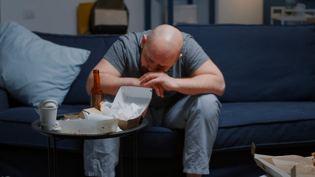 Hopeless depressed man overwhelmed by problems crying feeling loneliness, chronic fatigue upset suffering from migraine anxiety. Stressed unhealthy lonely male having bipolar disorder major depression