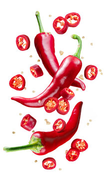 Fresh red chilli peppers and cross sections of chilli pepper with seeds floating in the air. File contains clipping paths.