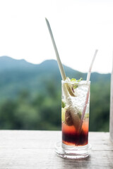 Iced plum juice mixed with lemon on wooden table