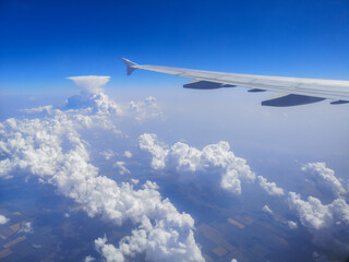 Airplane wing in sky in flight.