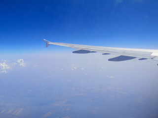 Fototapeta na wymiar Airplane wing in sky in flight.
