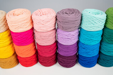 Rows of multicolored cotton yarn. The assortment of the store for needlework.
