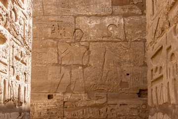 Ruin of Karnak Temple, ancient Egyptian murals and writings on the stone walls Luxor, Egypt