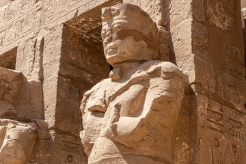 The statues of Pharaoh Ramses III as Osiris guarding the precinct of the temple of Karnak, Luxor,...
