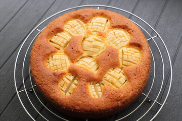 A delicious whole apple pie on a black table
