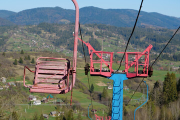 Old non-working chair lift in mountains