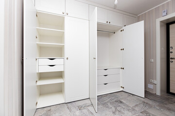 wardrobes with hinged doors on white door hinges, in the apartment - obrazy, fototapety, plakaty