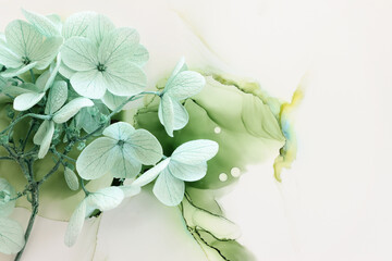 Creative image of pastel mint green Hydrangea flowers on artistic ink background. Top view with...