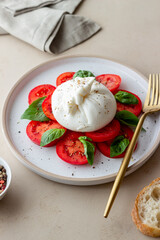 Italian burrata cheese with tomatoes and basil. Salad. Healthy eating. Vegetarian food.