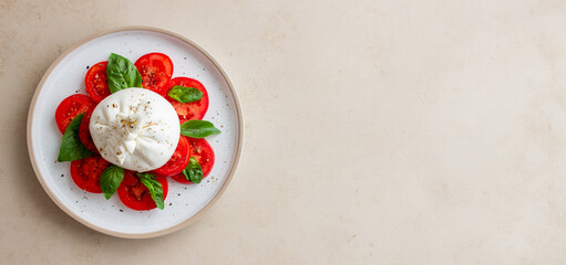 Italian burrata cheese with tomatoes and basil. Salad. Healthy eating. Vegetarian food.