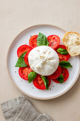 Italian burrata cheese with tomatoes and basil. Salad. Healthy eating. Vegetarian food.