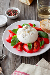 Italian burrata cheese with tomatoes and basil. Salad. Healthy eating. Vegetarian food.