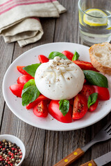 Italian burrata cheese with tomatoes and basil. Salad. Healthy eating. Vegetarian food.