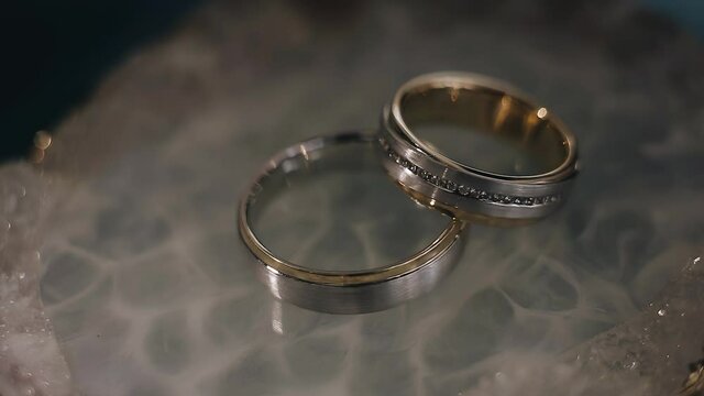 Close-up of gold wedding rings. Shooting with dynamic light