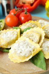 Concept of cooking ravioli on blue background