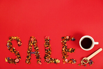 Wording Sale made of Fruit and berry dry tea leafs on red background,flat lay.Copy space,top...