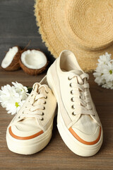Concept of summer sneakers on wooden background