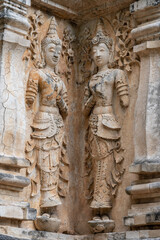 Fototapeta na wymiar Beautiful ancient stucco carving life size deities on wall of historic Wat Chet Yot or Wat Jed Yod buddhist temple, famous landmark of Chiang Mai, Thailand