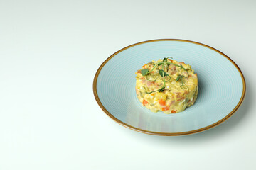 Plate with Olivier salad on white background