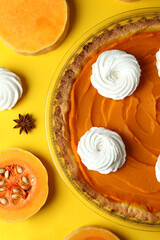 Obraz na płótnie Canvas Concept of tasty food with pumpkin pie on yellow background