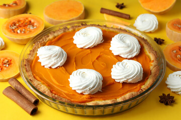 Obraz na płótnie Canvas Concept of tasty food with pumpkin pie on yellow background