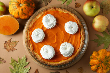 Concept of tasty food with pumpkin pie on beige background