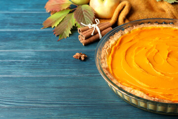 Concept of tasty food with pumpkin pie on wooden background