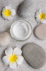 Spa treatment with massage stones and moisturizing cream
