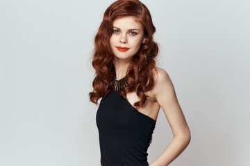 red-haired woman in black dress red lips glamor posing