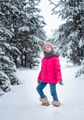 Fototapeta na wymiar Child in winter. A little girl, playing in the winter outside.