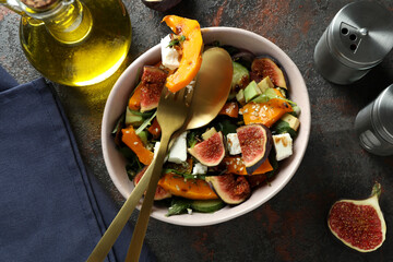Concept of tasty eating with pumpkin salad on dark background