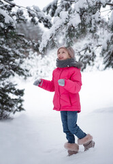 Child in winter. A little girl,  playing in the winter outside.