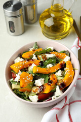 Concept of tasty food with pumpkin salad on light background