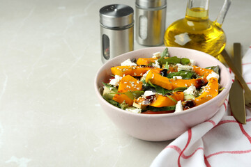 Concept of tasty food with pumpkin salad on light background