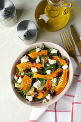 Concept of tasty food with pumpkin salad on light background