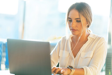 Businesswoman working on laptop in cafe