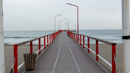 pier in the sea, wooden bridge in the sea, Long Narrow Pier Extending into the Sea