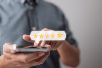 close-up of a customer hand pressing on a smartphone screen with a gold five-star rating feedback...
