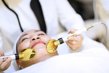 Woman getting laser and ultrasound face treatment in medical spa center. skin rejuvenation concept. woman laying eyes closed, receiving facial beauty treatment in beauty saloon.