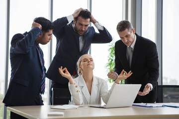 business woman meditating with angry colleagues