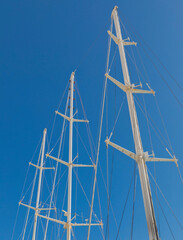 Ship's  Masts. Blue sky in the background. Three large masts  isolated. Stock Image.