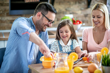 Family making fresh orange juice