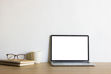 Mock up computer with books and coffee mug on table. 